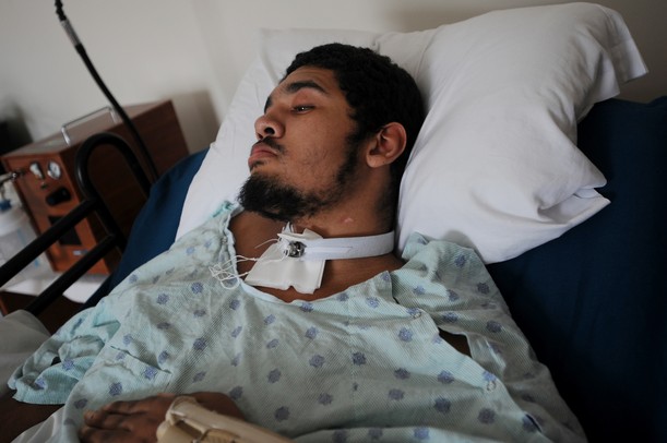 Lukequan Williams rests in his bed after being dropped off from the hospital. A scar on his neck marks the spot where he was accidentally shot by his cousin who was playing with a gun and subsequently paralyzed Williams from the neck down. Melanie Maxwell I AnnArbor.com